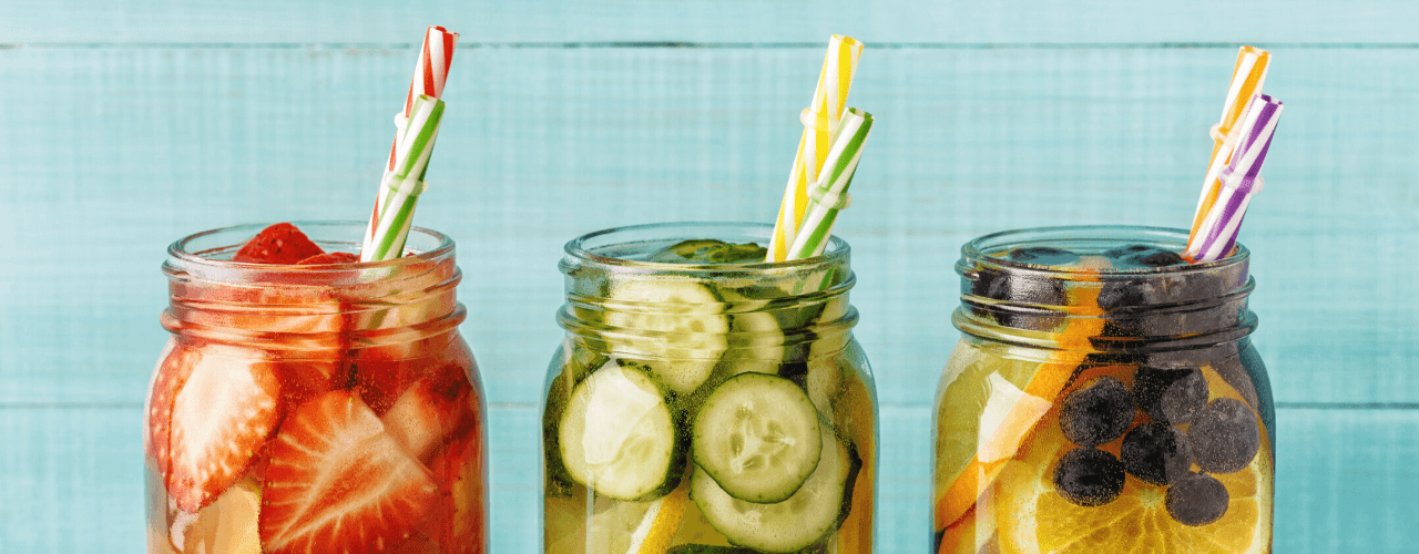 Mason jars filled with assorted fruits floating in water.