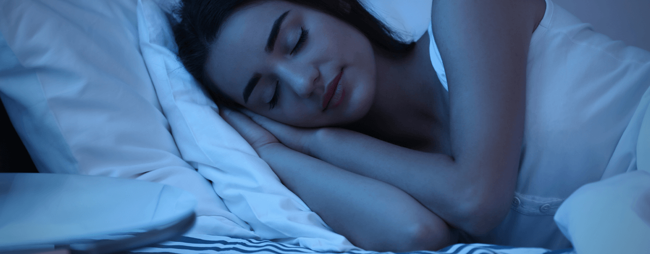 Girl sleeping in bed in dark room