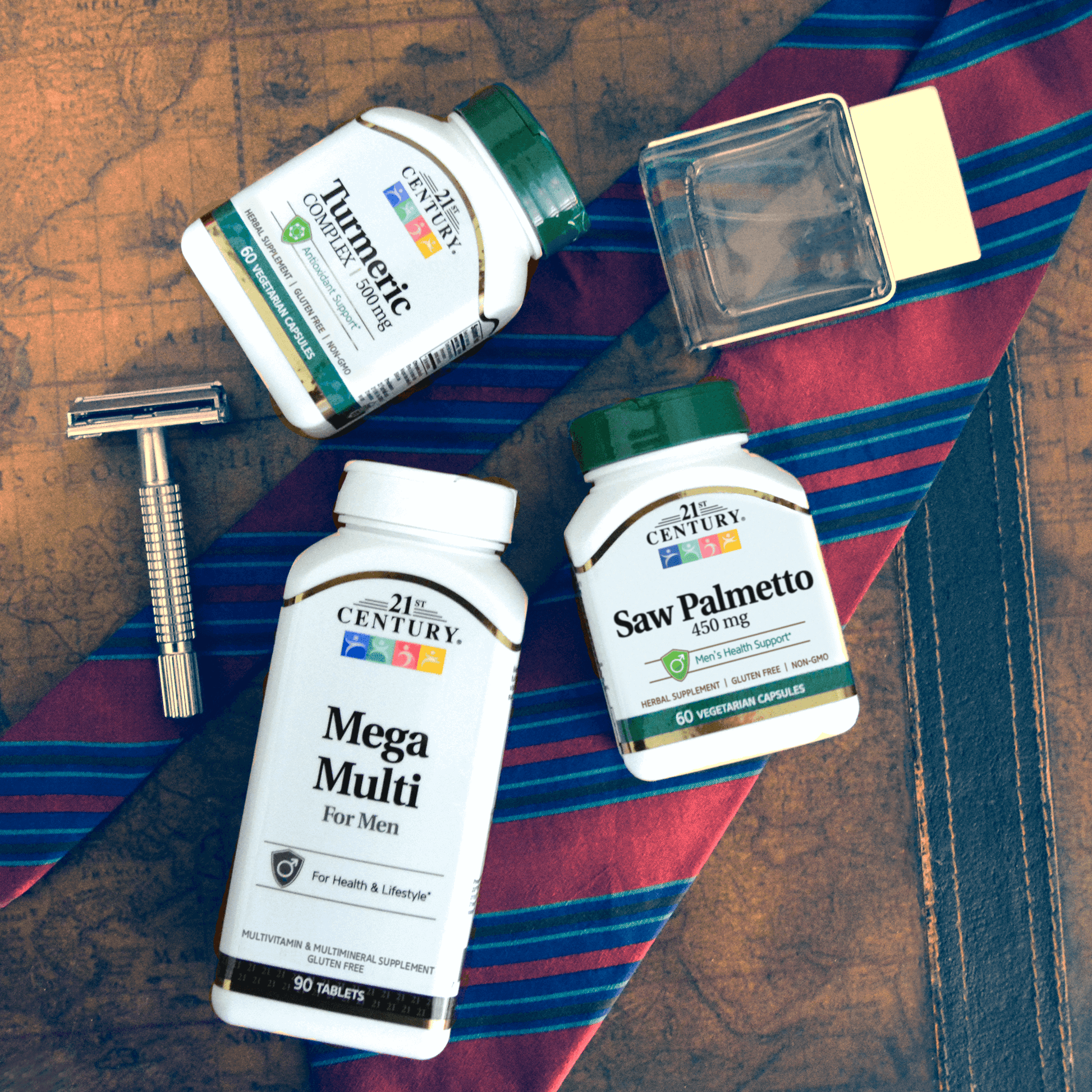 A group shot with a bottle of 21st Century Saw Palmetto 450 mg vegetarian capsules, Mega Multi Mens and Turmeric 500 mg Complex with a tie and men's razor.