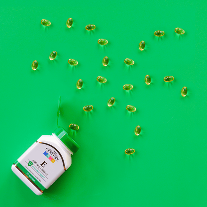 A bottle of 21st Century Vitamin E 450 mg softgels with vitamin e softgels coming out of the top in the shape of a firework.