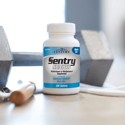 A bottle of 21st Century Sentry Senior Men's 50+ Multivitamin and Multimineral tablets on a table with a dumbbell in the background.