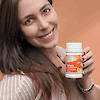 A young woman holding a bottle of 21st Century One Daily Women's Multivitamin and Multimineral tablets while smiling.