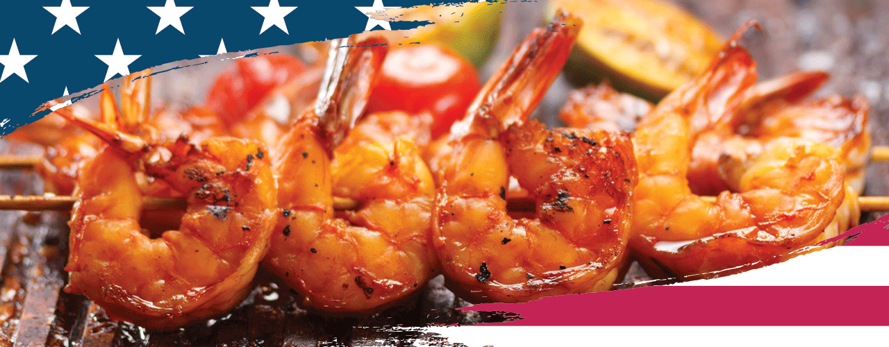 Delicious looking shrimp skewers on a grill top.