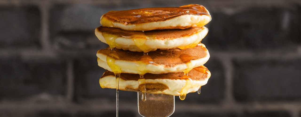 A yummy stack of pancakes on a fork.