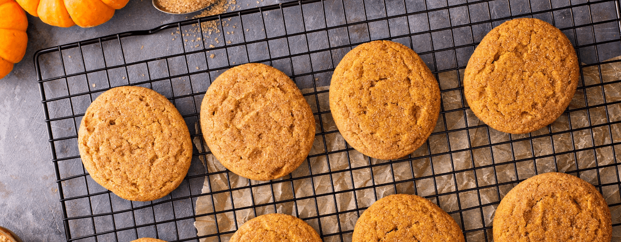 Pumpkin cookies on a cooling rack.
