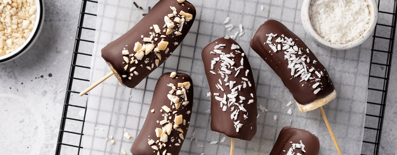 Delicious chocolate covered bananas on a cooling rack.