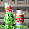 A bottle of 21st Century Calcium 500 plus D3 tablets sitting in a glass of tablets with another bottle to the right.