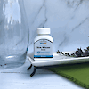 A bottle of 21st Century Slow Release Iron high potency tablets on a tray next to a glass vase.