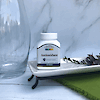 A bottle of 21st Century Antioxidant tablets sitting on a plate.