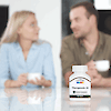 A bottle of 21st Century Therapeutic-M tablets with a man and woman in the background having coffee and talking to each other.