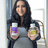 A pregnant woman holding a bottle of A bottle of 21st Century PreNatal DHA softgels and 21st Century PreNatal Multivitamin tablets.