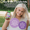 An image of a blond woman smiling and holding a bottle of vitajoy fiber 5 g gummies, product directions and the copy take you fiber gummies at the same time every day to establish a healthy routine, take charge of your daily wellness by supporting a healthy lifestyle.