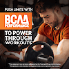 A man performing preacher curls with a preacher barbell and the claim push limits with bcaa performance to power through workouts.