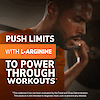 A close up image of a man with a weighted barbell on his back and the claim push limits with L-Arginine to power through workouts.